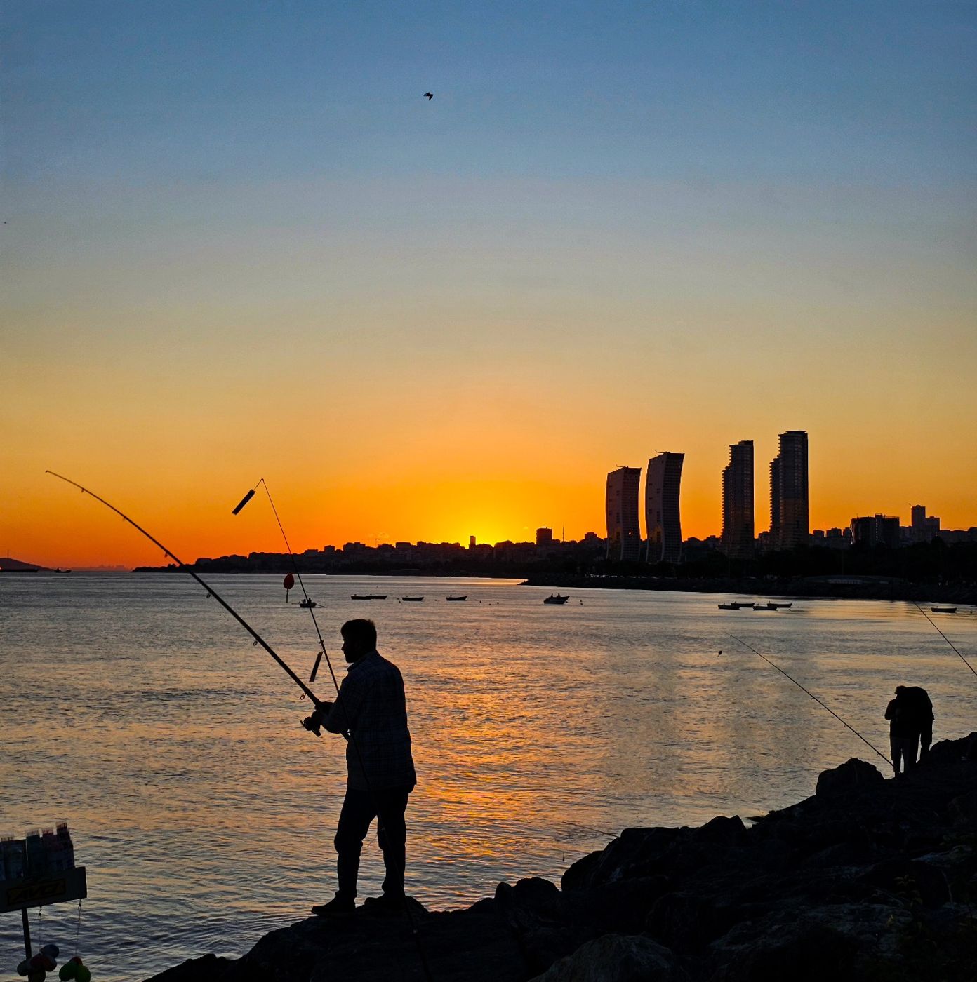 Fisherman silhouette at sunset on the Bosphorus by Mohammad Khakpaki