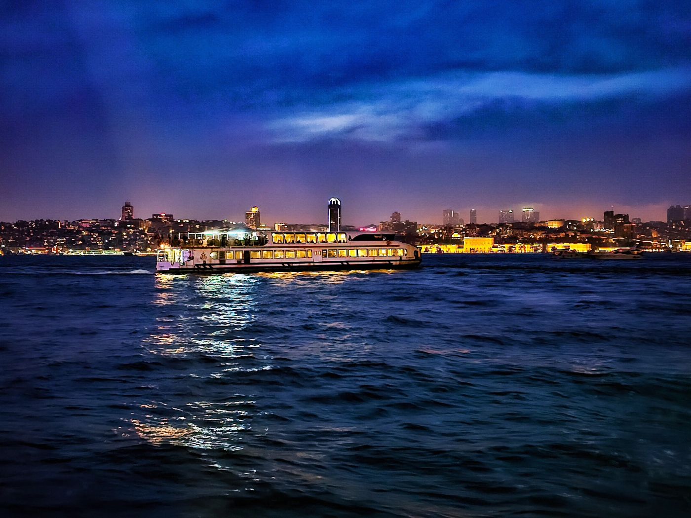 Istanbul skyline at night across the water by Mohammad Khakpaki
