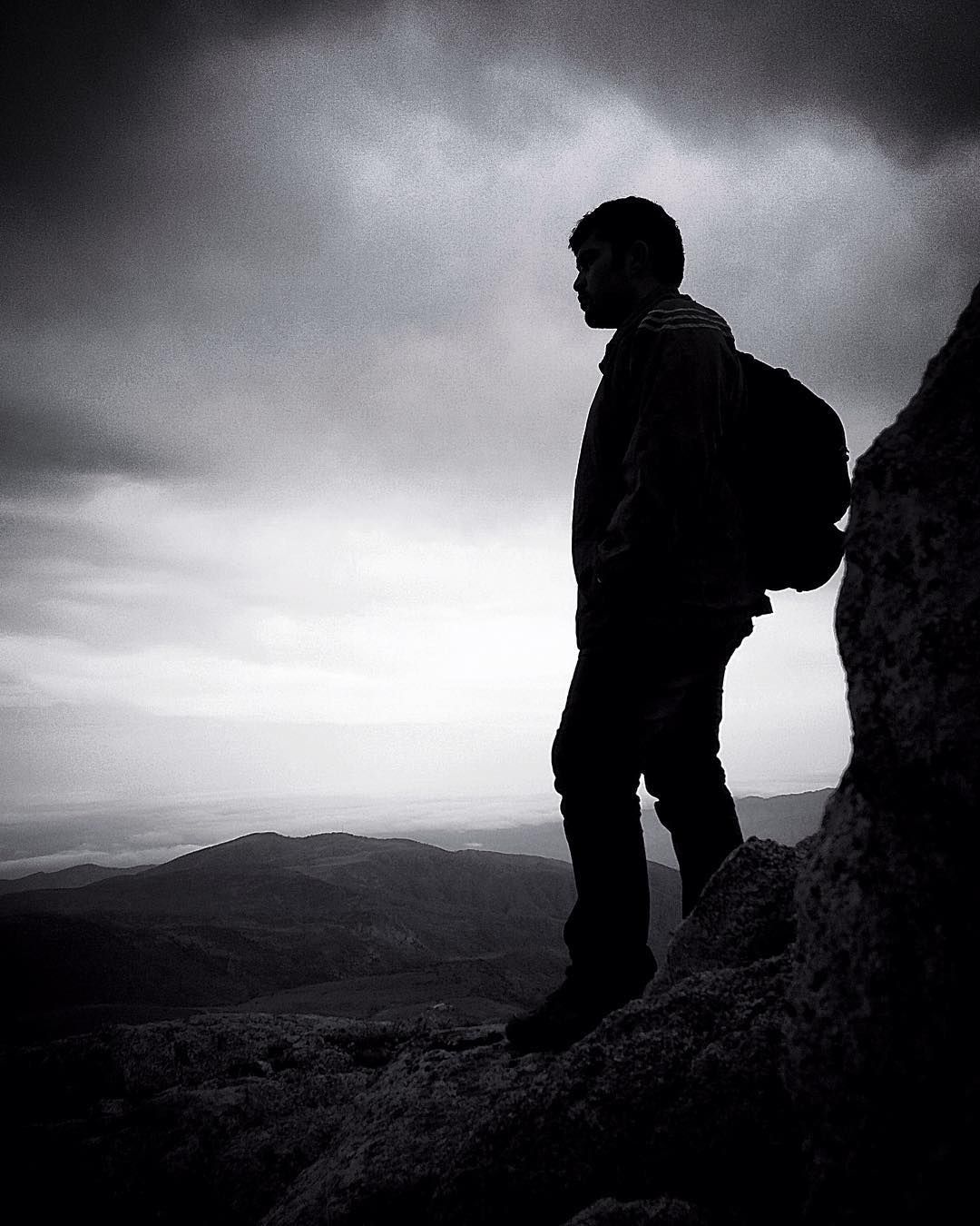 Hiker silhouette on a mountain, black and white by Mohammad Khakpaki
